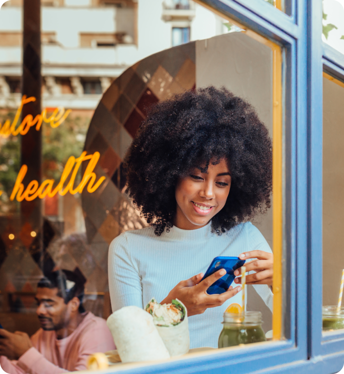 Woman using phone at coffee shop